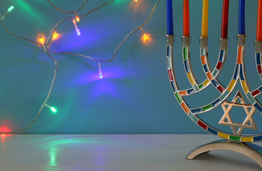 image of jewish holiday Hanukkah background with menorah (traditional candelabra) and candles.