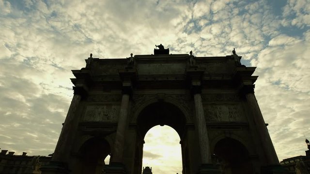 The gate to the Louvre in a time-lapse with fast moving clouds.