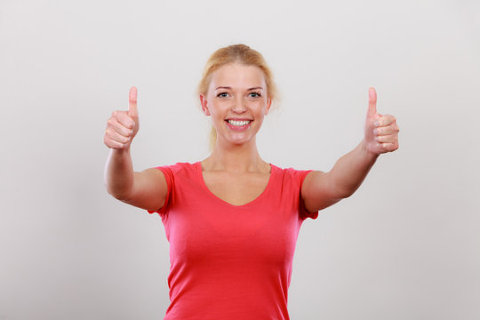Happy woman showing thumbs up gesture