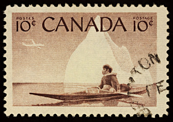 Eskimo in a kayak on postage stamp
