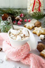 Christmas background frame or greeting xmas card. Christmas table decor and a cup of hot chocolate with a warm scarf. Сopy space.
