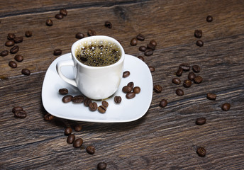 Coffee cup with fresh coffee on a wooden table
