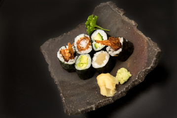 Sushi maki rolls with salmon, avocado and prawns