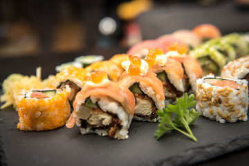 Sushi rolls on a black plate