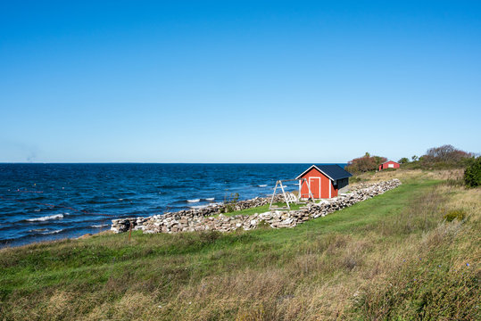 Traditional red cottage during autumn on Swedish Baltic sea island Oland. Oland is a popular tourist destination in Sweden during summertime.