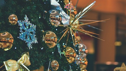 Christmas tree with ornaments. Blurry blank background.