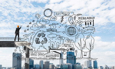 Businessman drawing ecological conceptual sketches