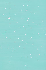 turquoise wooden background with shiny silver stars. Holidays, Christmas or any other celebration.