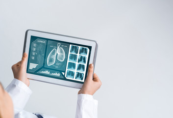 Close of female doctor hands working with tablet pc computer