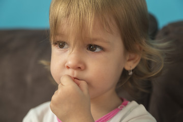 a beautiful little girl looks sad