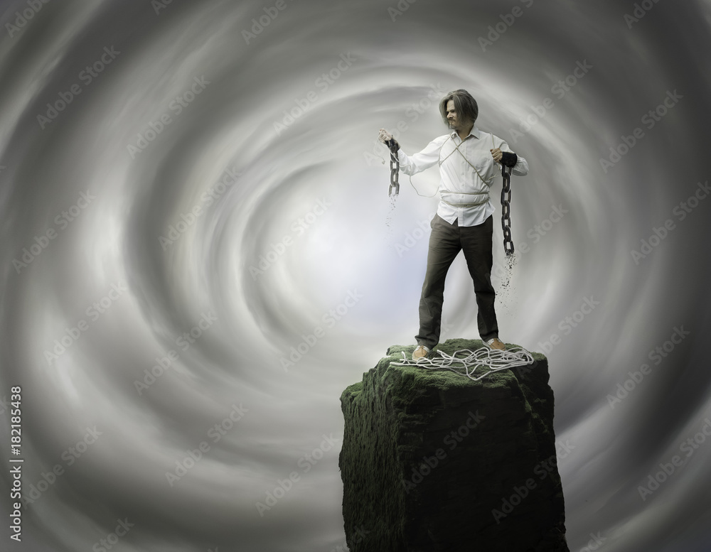 Wall mural man standing and looking on broken chains with open heaven behind him - christian freedom concept