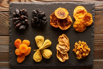 Fototapeta premium Dried fruits on slate plate