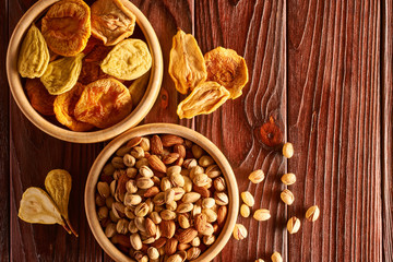 Dried fruits and nuts on wooden background