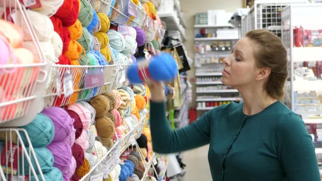 Woman Choosing Yarn for Knitting in Shop for Hobby and Handmade.