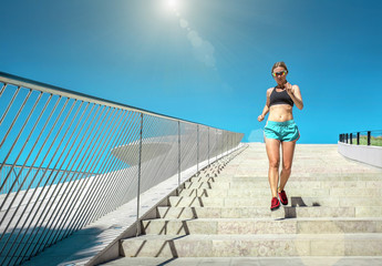 Blonde woman running training near the modern architecture build