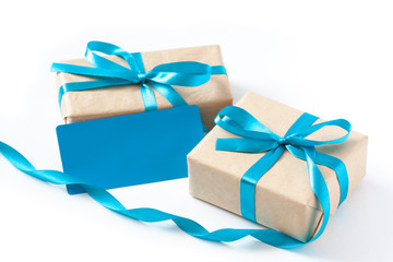 Two gift boxes wrapped in paper, tied with blue ribbons and blank note card, festive packaging mock...