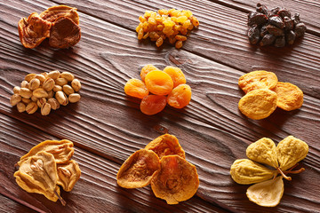 Fototapeta premium Dried fruits and nuts on wooden background