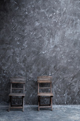 Fototapeta na wymiar Old vintage chair wooden at dark concrete wall texture
