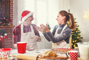 happy married couple baking christmas cookies