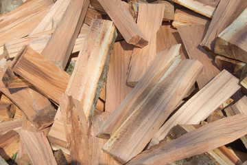 Firewood background - chopped firewood on a stack. Dry chopped firewood logs in a pile