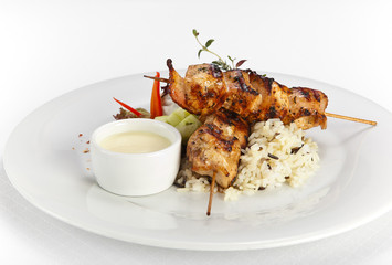 big pieces of grilled chicken, garnished with rice