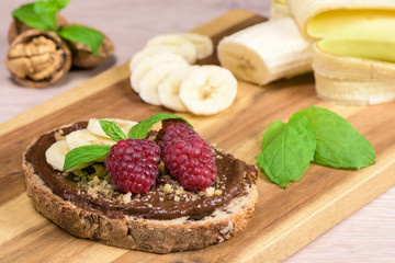 Healthy food - slice of bread witch chocolate cream made with avocado and banana.
