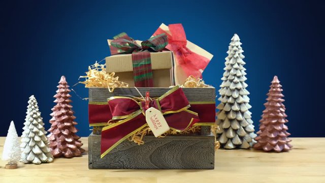 Stacking large English style traditional Christmas hamper with paper wrapped gifts and food, real time