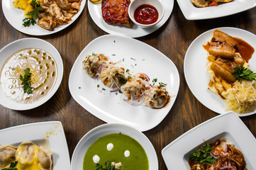 dishes with different food on the wooden table. top view