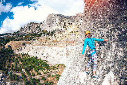 Girl climbs the rock.