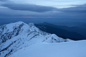 Winter landscape of mountains at sunset