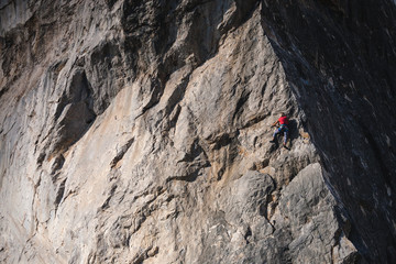 The girl climbs the rock.