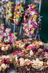Christmas market of home made wreaths and other composition from dry flowers