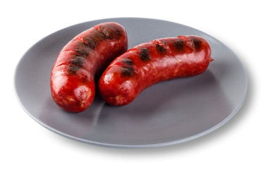 Two fried sausages on gray plate isolated on white background