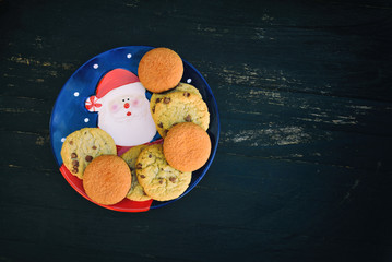 Christmas and New Year plates with sweets on a black background
