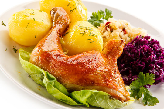 Roast chicken legs with potatoes and vegetables 