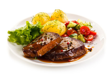 Grilled steak with vegetables on white background 