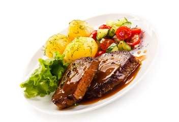 Grilled steak with vegetables on white background 