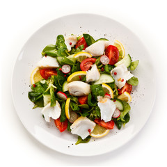 Salad with grilled fish fillet on white background 
