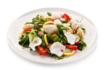 Salad with grilled fish fillet on white background 