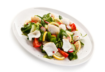 Salad with grilled fish fillet on white background 