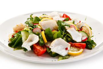 Salad with grilled fish fillet on white background 