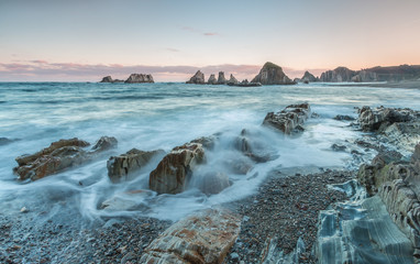 The beach of Gueirúa, small cove of pebbles that stands out above all for its landscape of great beauty with a row of small islands of sharp stone that come out of the ocean