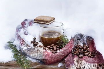 Cup of Coffee  Wrapped in a Knitted Scarf  on the Snow