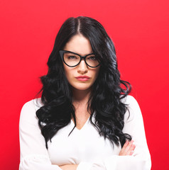 Unhappy young woman on a solid background