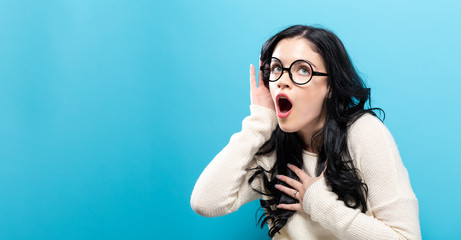 Young woman listening to something on a solid background