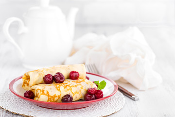 Sweet pancakes with cherry