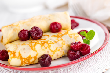 Sweet pancakes with cherry