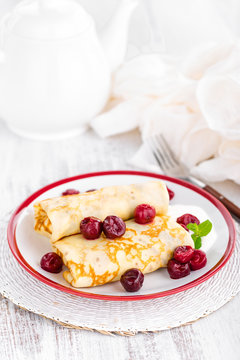 Sweet pancakes with cherry