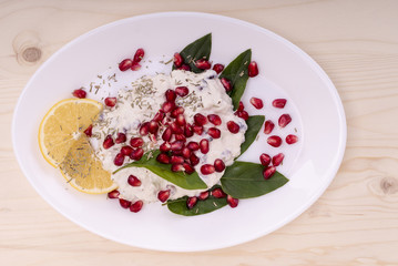 salad with chicken breasts, mayonnaise and pomegranate