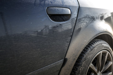 Part of a dirty car close up.